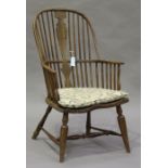 A 19th century American ash and elm spindle and splat back Windsor armchair, the shaped seat