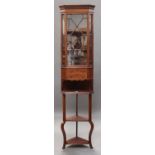 An unusual Edwardian mahogany and satinwood crossbanded narrow corner cabinet, the astragal glazed