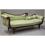 A Regency mahogany and brass inlaid scroll arm settee, upholstered in green patterned fabric, on