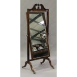 An Edwardian mahogany and bellflower inlaid cheval mirror, the swan neck pediment above a bevelled