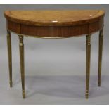 A George III Adam period satinwood demi-lune fold-over card table, the tulipwood crossbanded top