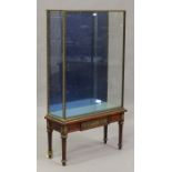 An early 20th century Louis XVI style mahogany and brass framed display case, the cast tied ribbon