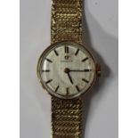 An Omega 9ct gold circular cased lady's bracelet wristwatch, the signed silvered dial with baton