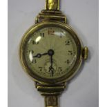 A Longines 9ct gold circular cased lady's wristwatch with a signed jewelled lever movement, the