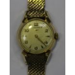 A Longines 9ct gold circular cased lady's wristwatch, the signed silvered dial with gilt Arabic