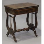 A mid-Victorian figured mahogany fold-over card table, fitted with a drawer raised on twin lyre