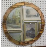 An Art Deco circular wall mirror with a sectional peach tinted surround, diameter 60cm.Buyer’s