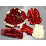 A small group of mainly early 20th century red velvet children's fancy dress clothing, including