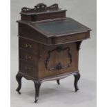 An Edwardian mahogany Davenport, fitted with a pen compartment above a hinged writing surface and