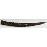 A 19th century Benin carved ivory tusk, profusely worked with bands of warriors, length 56cm.Buyer’s