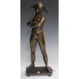 A modern brown patinated cast bronze figure of a standing harlequin wearing a face mask and with his