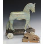 A 20th century carved and painted push-along model of a horse, length 46cm, together with a folk art