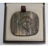 A late 20th century brown patinated cast bronze commemorative medallion, one side depicting the
