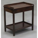 A 20th century mahogany side table, the galleried top above an end drawer, on block legs united by