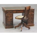 A Victorian mahogany and stained pine twin pedestal desk, fitted with nine drawers, on plinth bases,