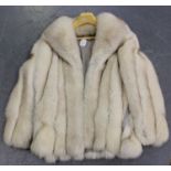 A late 20th century silver fox fur half-length lady's coat, length 73cm.Buyer’s Premium 29.4% (