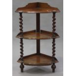 A mid-Victorian oak three-tier corner whatnot, the shaped gallery and moulded top raised on barley