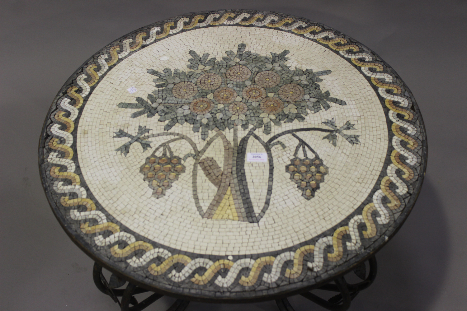 An early 20th century circular coffee table with mosaic top, on a wrought metal scrolling base, - Image 2 of 2