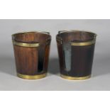 A near pair of George III Irish mahogany plate buckets, both fitted with brass swing handles and