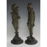A pair of late 19th century French patinated spelter figural candlesticks in the form of humorous