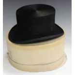 A black moleskin top hat by Bates, London, size 7¼, 59.Buyer’s Premium 29.4% (including VAT @ 20%)