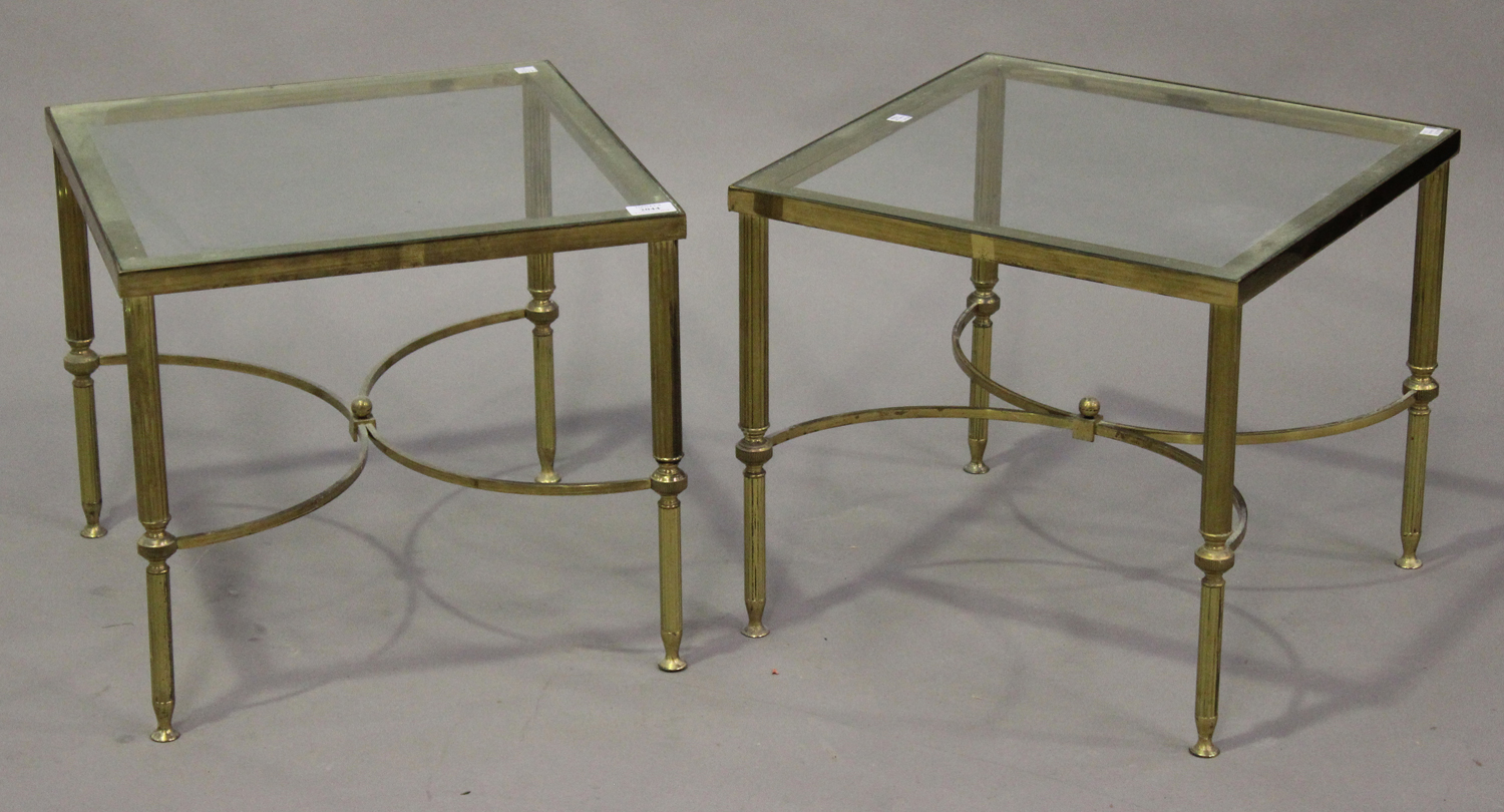 A pair of mid-20th century gilt brass square occasional tables, inset with glass tops, raised on