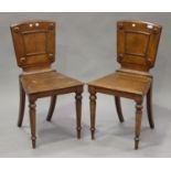 A pair of late Victorian oak hall chairs, on octagonal tapering legs, height 87cm, width 46cm.