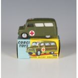 A Corgi Toys No. 414 Bedford Military Ambulance with plain metal wheels, within a blue and yellow