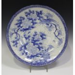 A Japanese Arita blue and white porcelain circular charger, Meiji period, painted with a peacock