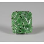 A Chinese apple green jade plaque, early 20th century, of rectangular form, carved and pierced