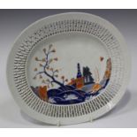 A Chinese export porcelain reticulated oval dish, Qianlong period, painted in blue, iron red and