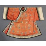 A Chinese coral-coloured silk embroidered jacket/short robe, late Qing dynasty, finely worked in