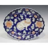 A Japanese Imari porcelain dish, Meiji period, of oval shape with scalloped rim, relief moulded to