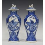 A pair of Chinese blue and white export porcelain vases and covers, mark of Kangxi but late 19th