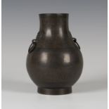 A Chinese archaistic brown patinated bronze and wire inlaid two-handled hu vase, 19th century, the