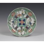 A Chinese famille verte porcelain saucer dish, Kangxi period, enamelled with a design of four leaf