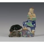 A Chinese export porcelain figure group, Qing dynasty, modelled as a fisherman observing a large