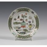 A Chinese famille verte porcelain plate, Kangxi period, the centre painted with precious vessels,