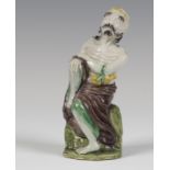 A Chinese famille verte enamelled biscuit porcelain figure of a luohan, Kangxi period, the