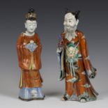 A pair of rare Chinese enamelled export porcelain figures of a bearded gentleman and lady,