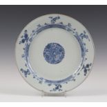 A Chinese blue and white porcelain circular dish, Kangxi period, painted with a central foliate