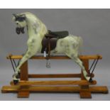 A late 20th century dapple grey rocking horse by Haddon Rockers, with leather saddle and mane,