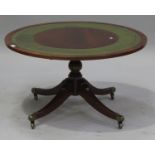 A late 20th century reproduction mahogany circular coffee table, the top inset with a green