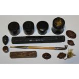 A selection of various collectors' items, including a Japanese white metal and bamboo pipe, within a