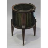 A 19th century Dutch mahogany planter, fitted with a brass swing handle and liner, the cylindrical