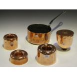 A group of three late 19th/early 20th century copper ring jelly moulds, another copper mould and a