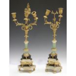 A pair of early 19th century porcelain, white marble and cast ormolu three light candelabra, each