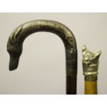 A late 19th century walking stick, the plated handle in the form of a fox's head, the shaft carved