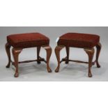A pair of late 20th century Queen Anne style walnut stools with overstuffed seats, on cabriole legs,