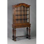 A late 19th century Dutch walnut display cabinet, the arch moulded pediment above a single glazed